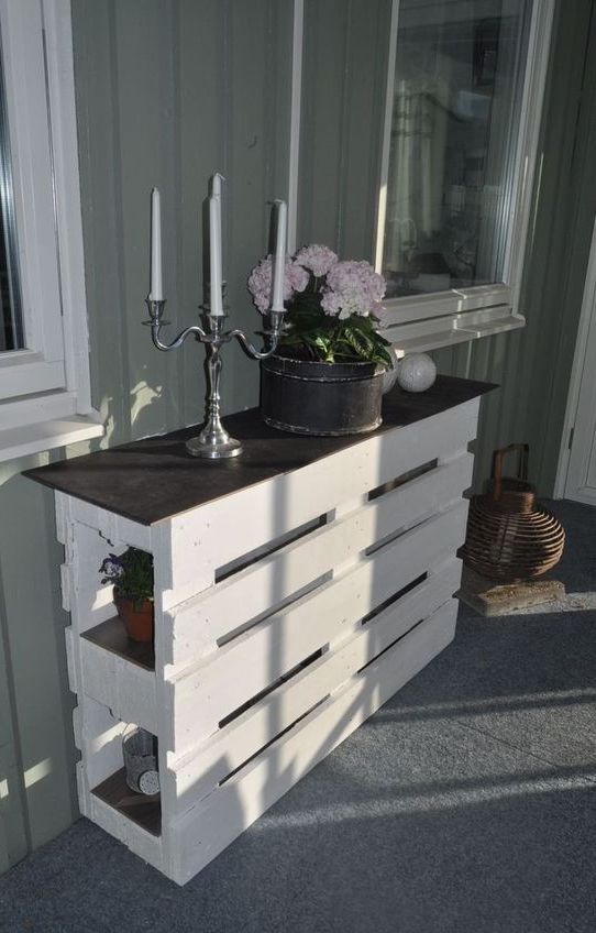 a chic pallet console table of two pieces painted white and a black tabletop looks cool and elegant