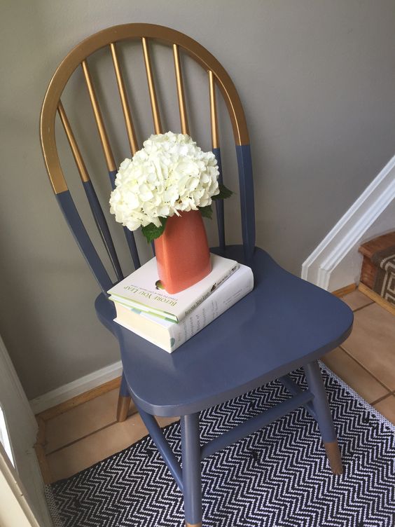 a gilded and navy color block chair looks much more modern and bold with this technique