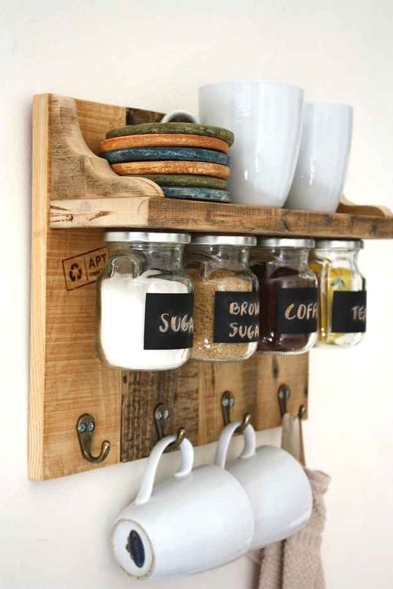 a stained rustic meets industrial rack with storage space, with jars on magnets and hooks for cups
