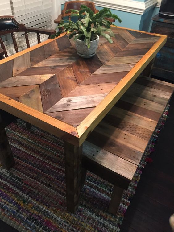 a rustic dining table with a chevron pattern pallet wood tabletop and slatted benches, with minimal staining