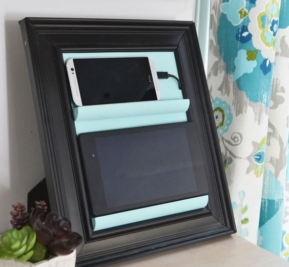 a small and comfortable charging station of a frame and some ledges is a cool idea for every space