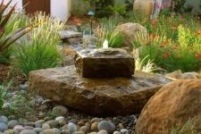 19 a gorgeous rock fountain looks very natural and cool in a desert garden