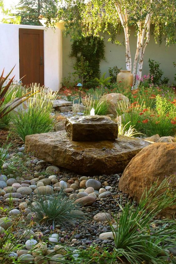 a gorgeous rock fountain looks very natural and cool in a desert garden