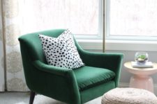 19 a green velvet chair with a polka dot pillow, a woven ottoman, a fur rug and a metal floor lamp