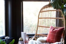 20 a hanging rattan birdcage chair with pillows, a blanket, a fur throw is a gorgeous base for a reading nook