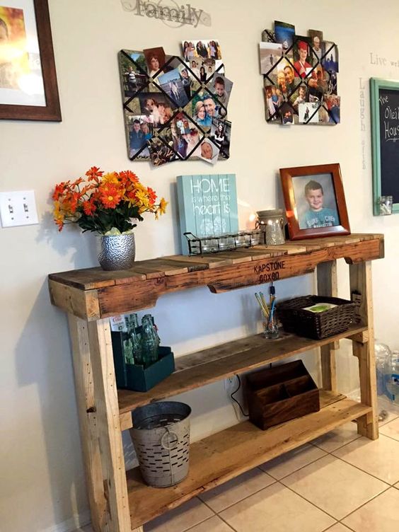 a rustic stained pallet console table with several shelves brigns enough storage space to the entryway