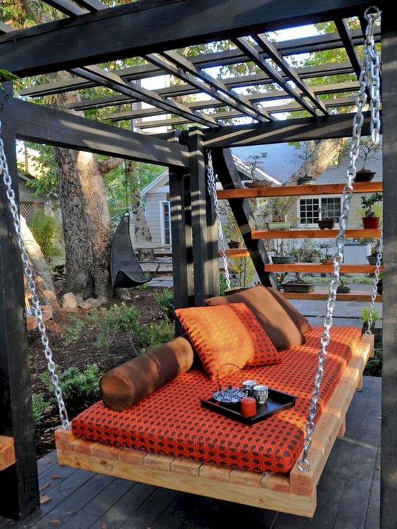 an outdoor pallet daybed hanging on chains is a super cool and relaxing idea for your space