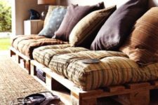 22 a welcoming pallet daybed with storage space, colorful textiles and pillows