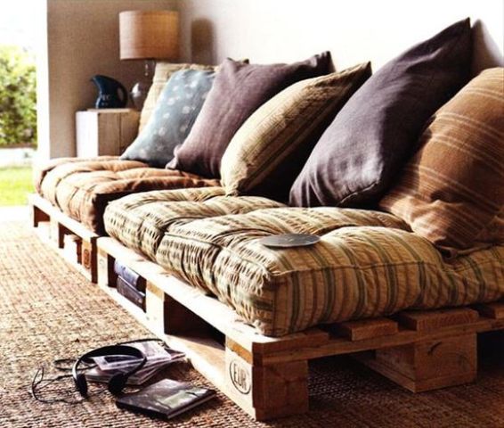 a welcoming pallet daybed with storage space, colorful textiles and pillows