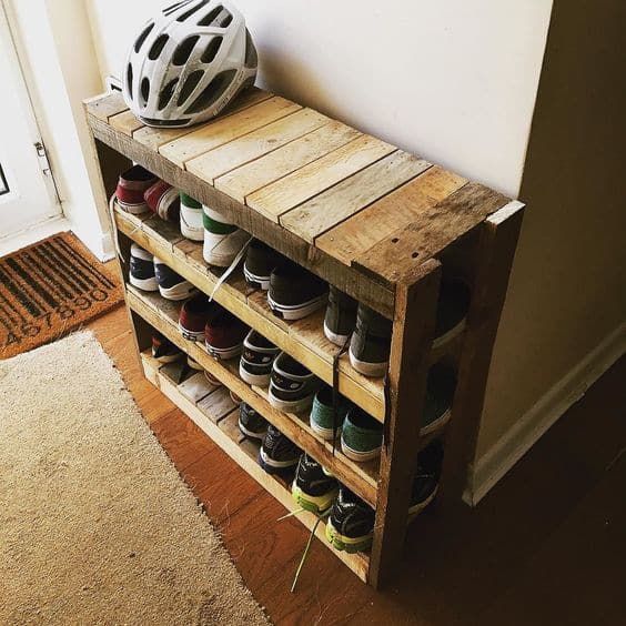 a simple rustic shoe rack built of pallet wood features several tiers to accommodate all your shoes, the piec ewill fit even a small entryway