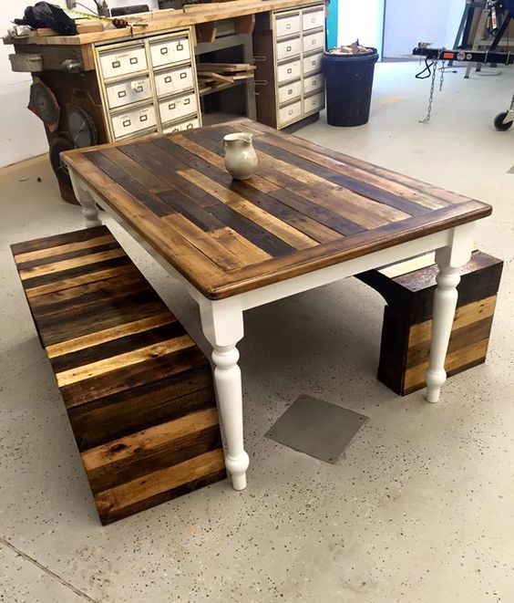 a vintage and rustic pallet furniture set of a table with refined legs and benches on both sides with bold staining