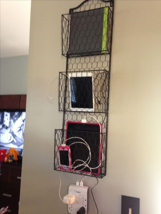 a wore basket hanging on the wall is ideal to charge your tablets and phones and can be hung anywhere