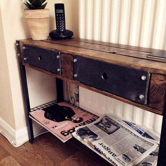 a vintage industrial console table built of pallets and metal details gives much storage space