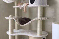 26 an ultra-modern cat tree with several platforms and beds, with scratcher posts and some hammocks