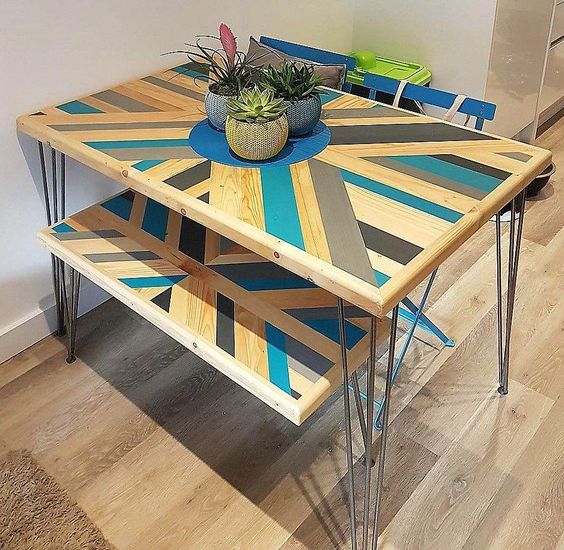 make your pallet dining table bold adding a pattern and some colors to it, here you'll also see matching benches
