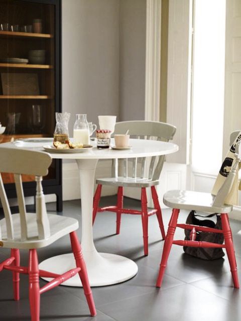 Vintage off white chairs and table and living coral legs give an edgy touch to the space