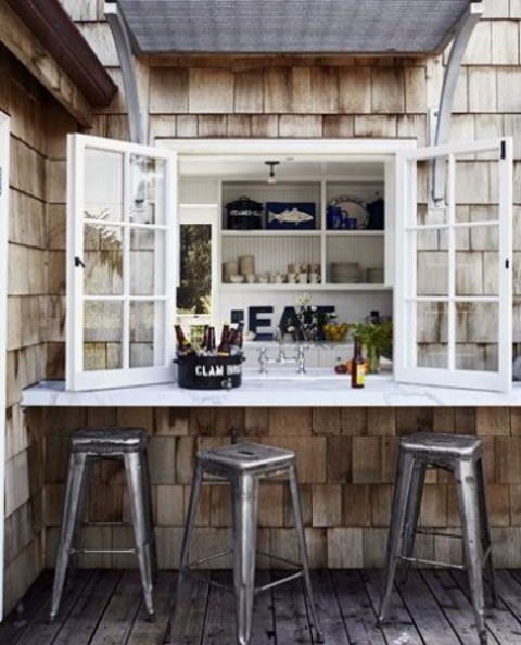 a usual window, a white tabletop and metal chairs make up a cool and bold industrial meal space