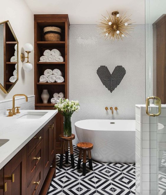 A contemporary meets mid century odern bathroom in black and white with much rich colored wood and gilded touches