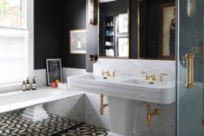a gorgeous art deco meets vintage bathroom in black and white, with a bath clad with mirrors and a large double sink