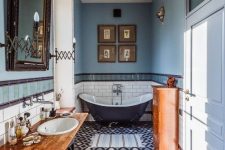 a gorgeous eclectic bathroom done in the shades of blue and copper, with lots of vintage items and furniture