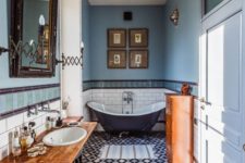 a gorgeous eclectic bathroom done in the shades of blue and copper, with lots of vintage items and furniture