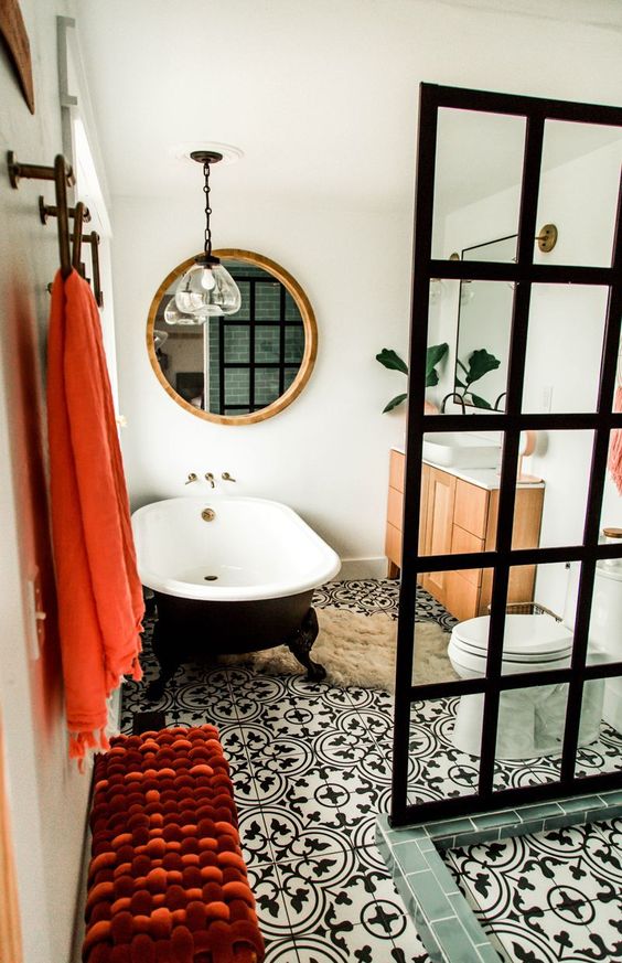 A mid century modern meets contemporary bathroom done in black and white and accented with coral