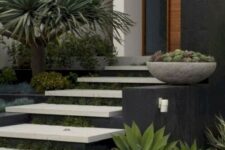 a modern front yard with neutral steps and greenery in between the steps, with trees and succulents around is a chc and bold space