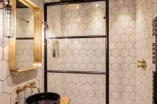 a stunning eclectic bathroom mixing industrial and contemporary bathroom and done in a black, white and gold color scheme