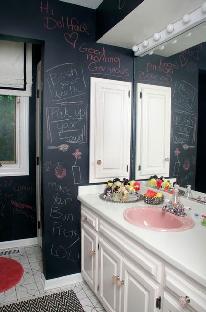 an eclectic bathroom with a vintage vanity and chalkboard walls to inspire kids' art and playing