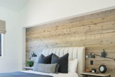02 a modern farmhouse bedroom with a statement neutral-colored shiplap wall that adds coziness and helps to pull off the style