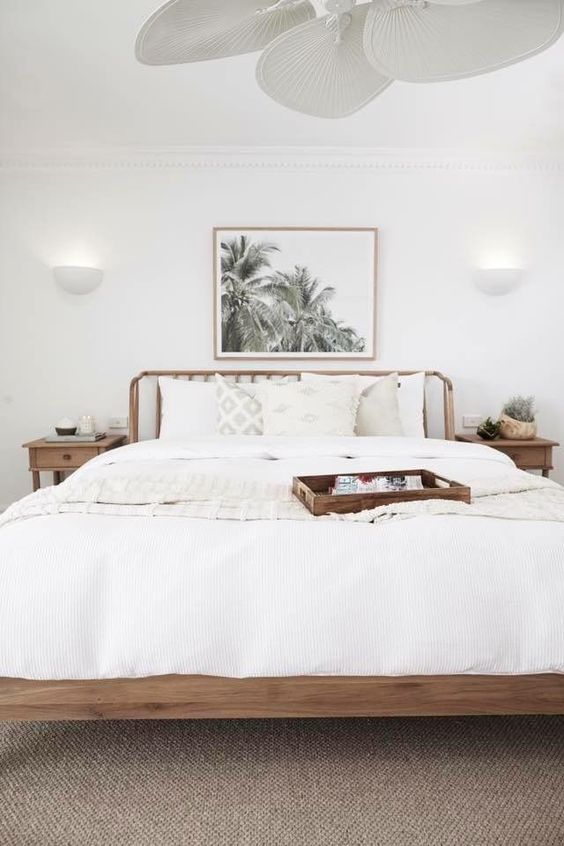 a neutral coastal bedroom, with everything white and a tan floor is a very welcoming space