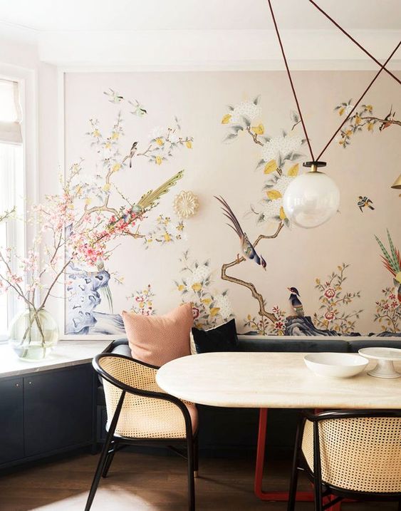 a refined dining space with a beautiful statement wall with flora and fauna that cozies up the space