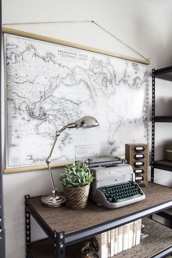 an industrial home office with a black and white world map as an artwork, it adds a refined and chic space
