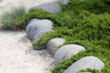 02 oversized rocks and white garden pathways create an Asian feeling in the garden makign it all-natural yet manicured