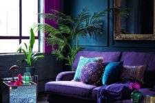 03 a bright purple sofa, pink curtains and a blue printed rug for brightening up a moody space