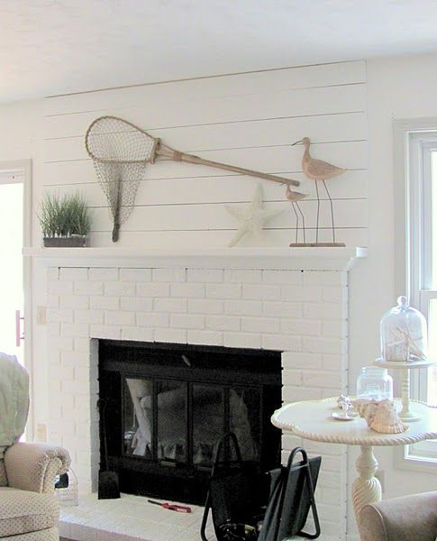 a coastal living room with a white brick clad fireplace - whte brick accents the fireplace and adds texture