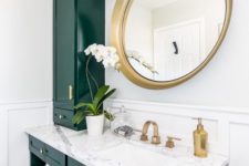03 a stunning emerald and white stone bathroom spruced up with gold hardware and a large round mirror