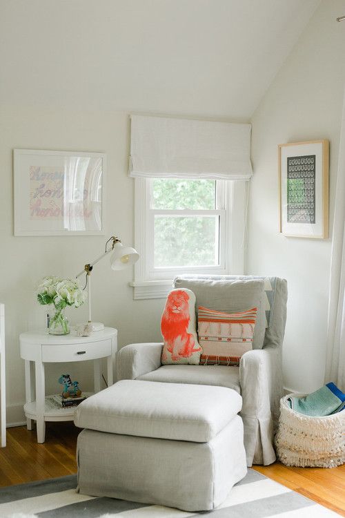 a cozy reading nook with a traditional feel and a small window with Roman shades in neutrals