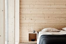04 a minimal Scandinavian bedroom with wooden walls, a floor and ceiling that make the space welcoming