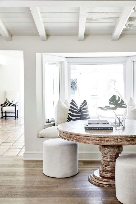 A neutral coastal space in creamy and off whites, with black and white accessories