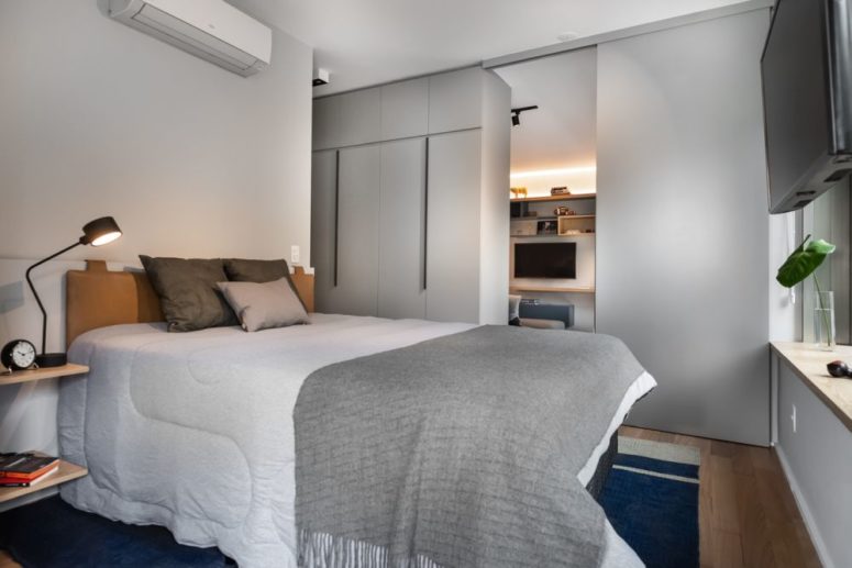 The second bedroom features a comfy leather upholstered bed, much storage and floating nightstands