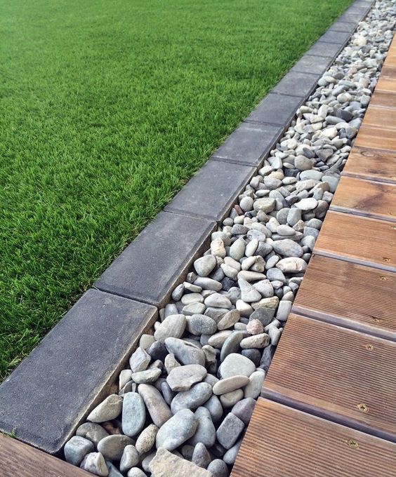 a pebble and dark brick border will fit a modern garden and will make it look edgy and stylish