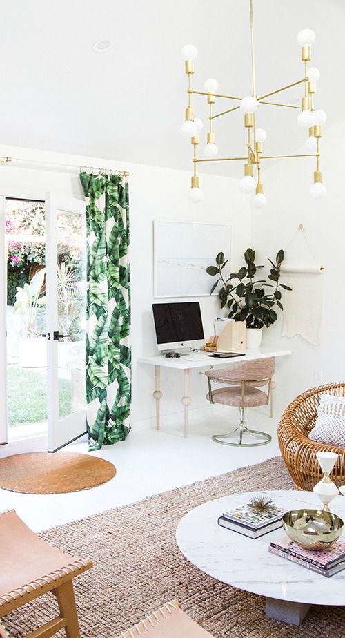 bright tropical leaf print curtains and brass accents bring a bright touch and timeless elegance