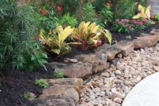 06 a large pebble and rough rock garden border brings much texture and a rough touch to the elegant outdoor space