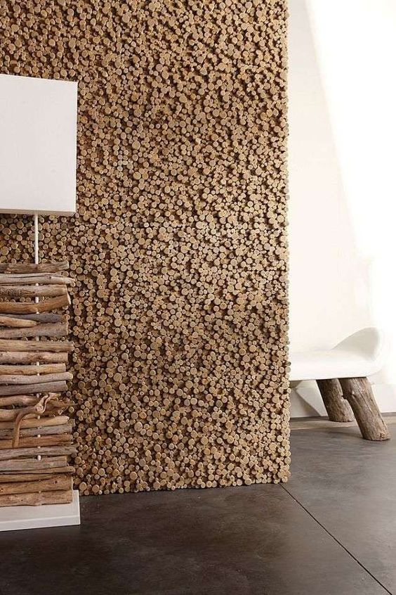 a pixelated wooden wall like this one is a cool idea to add texture and coziness to the space and it looks very catchy