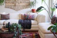 06 colorful printed pillows, a printed rug and a large macrame hanging make the space boho-like