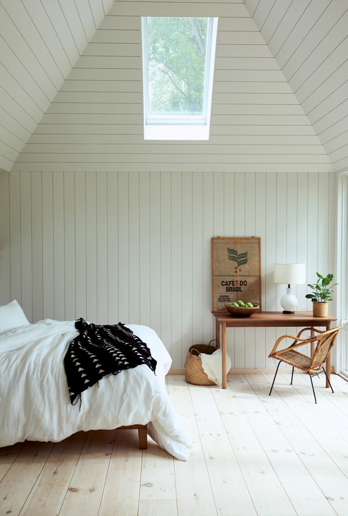 The bedroom is done with skylights, wooden furniture, wicker touches and potted greenery- there are no unnecessary items