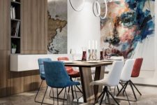 07 a contemporary dining room with white, red and blue mismatching chairs and a wooden table