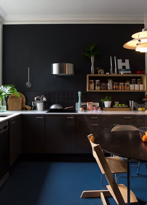 a white countertop and a navy floor add color to the kitchen making it look fresher