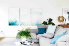 07 an airy coastal living room decorated in white, light grey, tan and with splashes of turquoise here and there